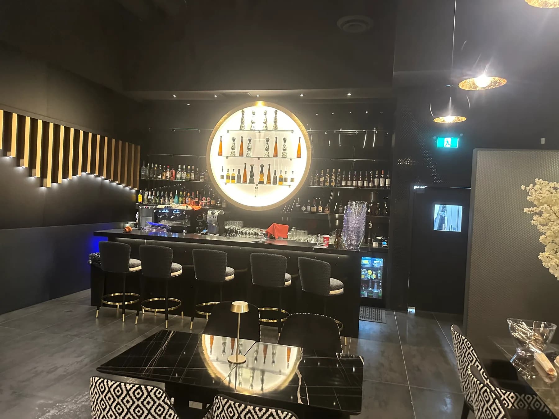 Bar counter and seating beneath a circular pendant light