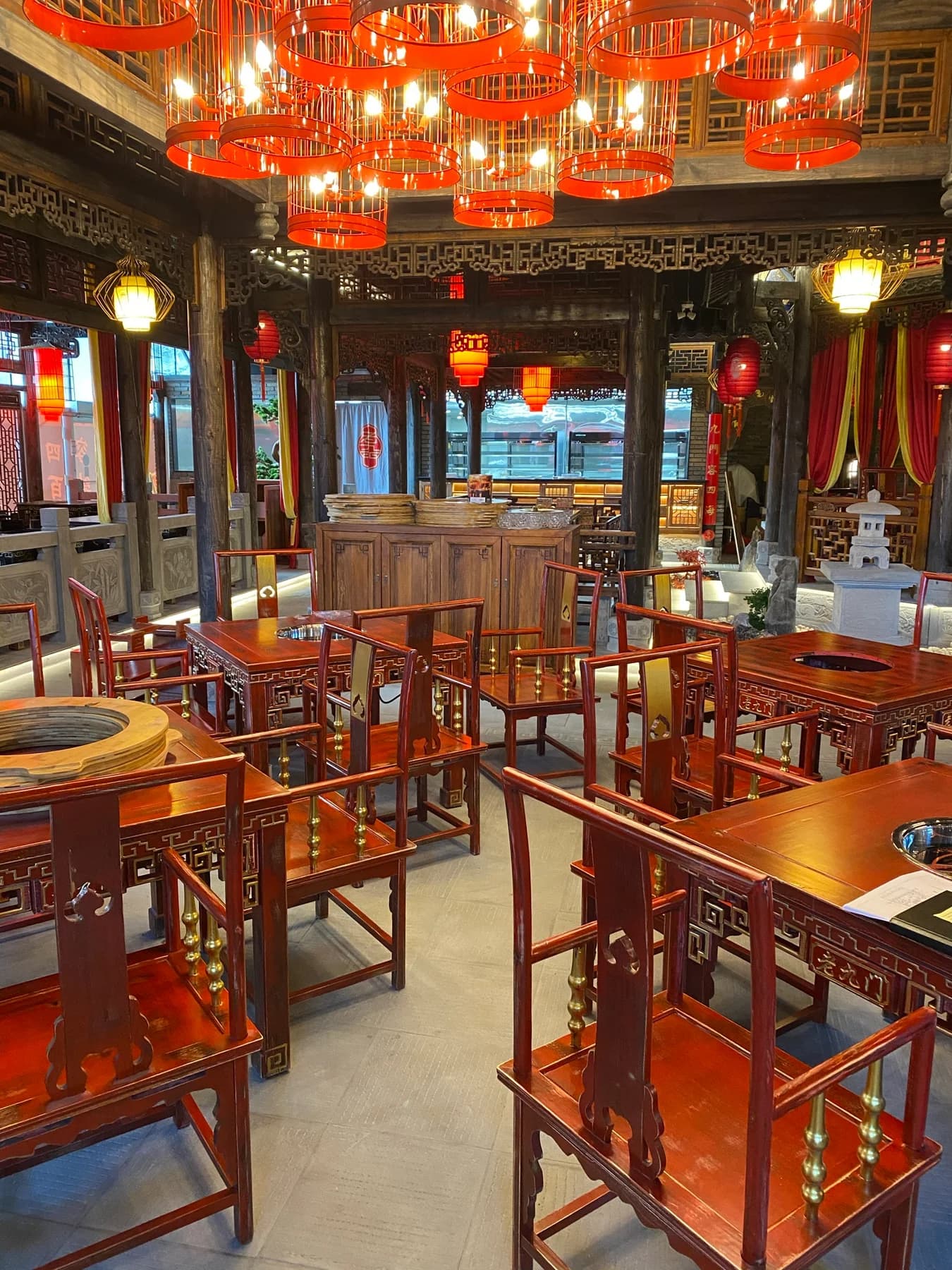 Restaurant dining room with timber seating and red lantern pendant lights