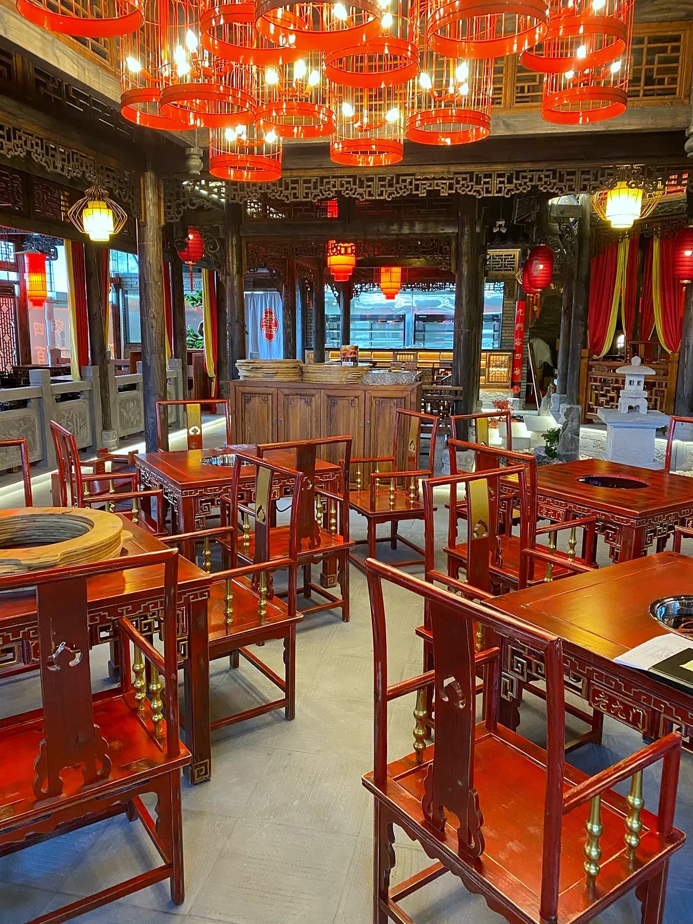 Restaurant dining room with timber seating and red lantern pendant lights
