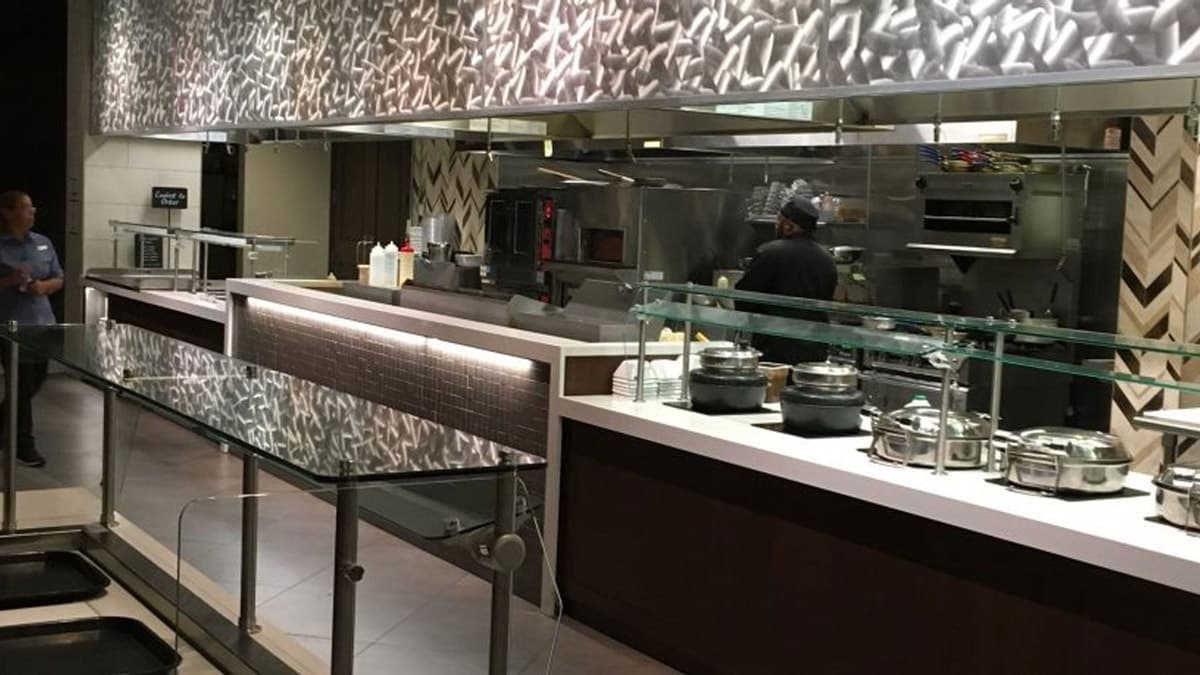 Restaurant service counter with a stainless-steel kitchen behind it